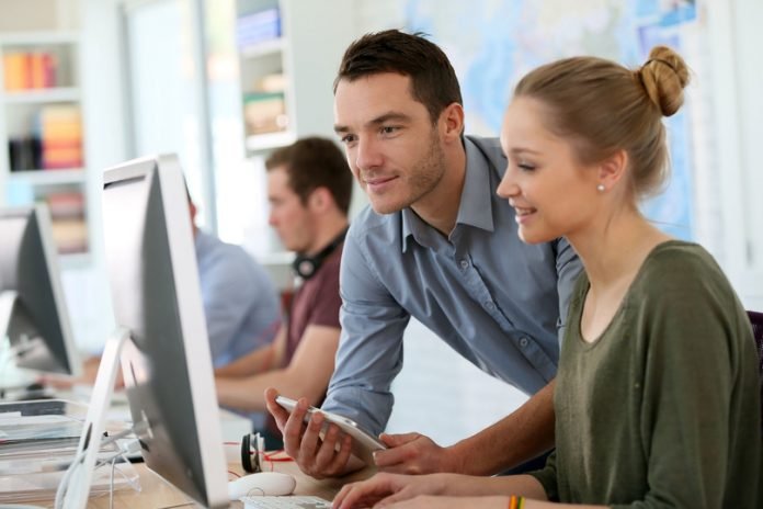 37491048 - student girl with trainer working on computer and tablet