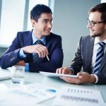 27769727 – image of two young businessmen communicating at meeting